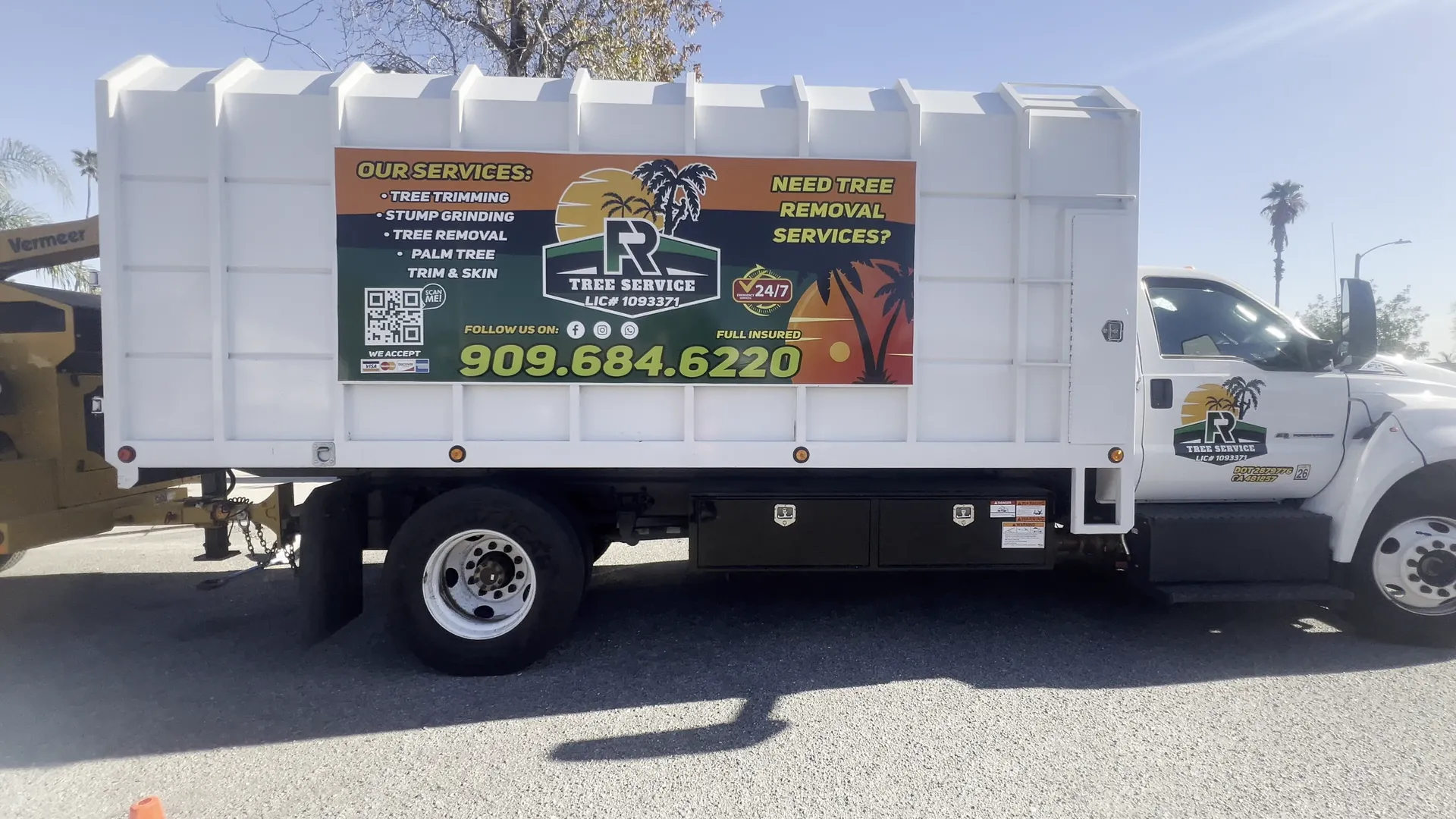 FR Tree Service dump truck with the company logo, services list and phone number on the side